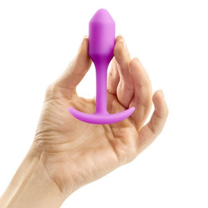 B-Vibe Snug Plug 1 Anal Plug FUCHSIA on hands
